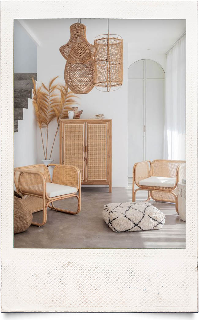 rattan-inspo faux fireplace and window mirror fresh flowers contrast tones living room inspiration inspo home design interior trends